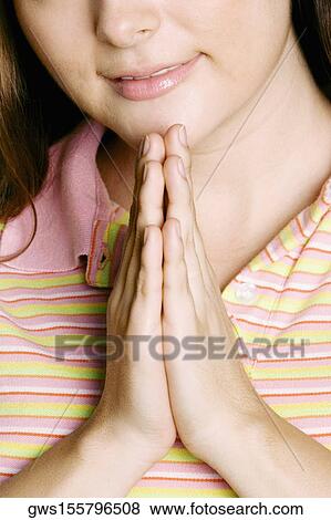 Stock Photo - Mid section view of a young woman greeting. Fotosearch