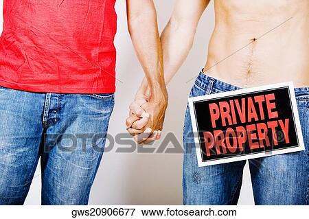 Mid section view of two men holding hands with a Private Property sign on the crotch of one of them View Large Photo Image Stock Photo - Mid section view of two men holding hands with a Private Property sign on the crotch of one of them. Fotosearch