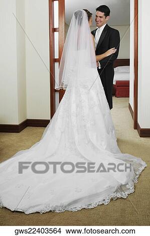Picture - Newlywed couple standing and looking at each other. Fotosearch