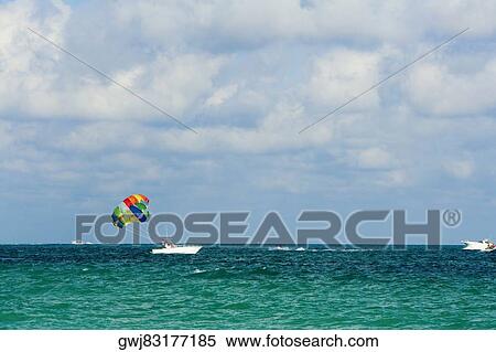 Parachute attached to a boat View Large Photo Image Stock Photography - Parachute attached to a boat. Fotosearch