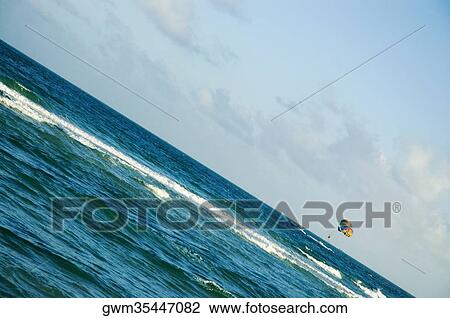 Parachute flying over the sea View Large Photo Image Stock Image - Parachute flying over the sea. Fotosearch