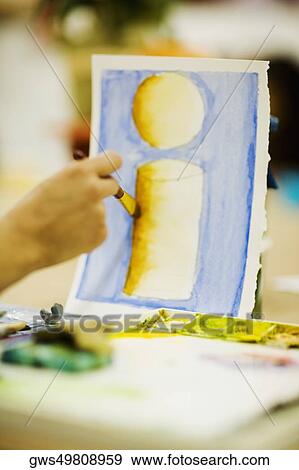 Person's hand painting on a sheet of paper View Large Photo Image Stock Photo - Person's hand painting on a sheet of paper. Fotosearch