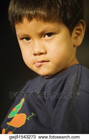 Portrait of a boy biting his lip View Large Photo Image Stock Image - Portrait of a boy biting his lip. Fotosearch