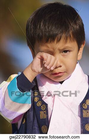 Stock Image - Portrait of a boy crying. Fotosearch
