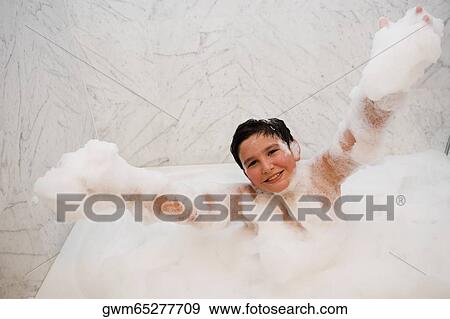 Portrait of a boy in a bubble bath View Large Photo Image Stock Photo - Portrait of a boy in a bubble bath. Fotosearch