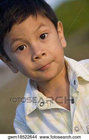 Portrait of a boy looking with his raised eyebrows View Large Photo Image Picture - Portrait of a boy looking with his raised eyebrows. Fotosearch