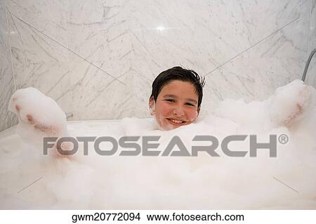 Portrait of a boy smiling in a bubble bath View Large Photo Image Picture - Portrait of a boy smiling in a bubble bath. Fotosearch