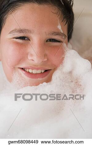 Portrait of a boy smiling in a bubble bath View Large Photo Image Stock Photo - Portrait of a boy smiling in a bubble bath. Fotosearch