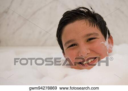 Portrait of a boy smiling in a bubble bath View Large Photo Image Stock Photo - Portrait of a boy smiling in a bubble bath. Fotosearch