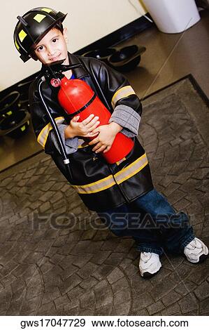 Portrait of a boy standing in a fireman costume View Large Photo Image Stock Photo - Portrait of a boy standing in a fireman costume. Fotosearch