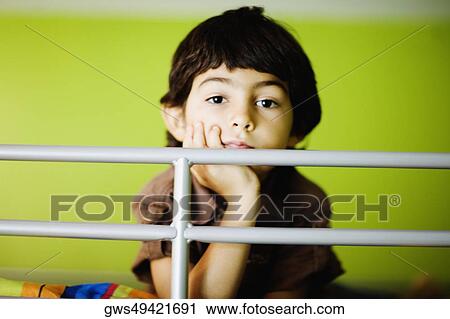 Stock Image - Portrait of a boy thinking. Fotosearch