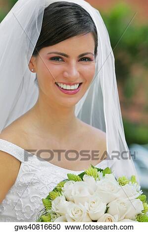 Portrait of a bride holding a bouquet of flowers and smiling View Large Photo Image Stock Image - Portrait of a bride holding a bouquet of flowers and smiling. Fotosearch