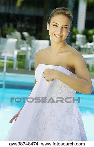 Portrait of a bride holding a veil and smiling View Large Photo Image Picture - Portrait of a bride holding a veil and smiling. Fotosearch