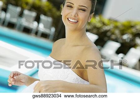 Portrait of a bride holding a veil and smiling View Large Photo Image Picture - Portrait of a bride holding a veil and smiling. Fotosearch