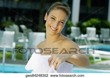 Portrait of a bride holding a veil and smiling View Large Photo Image Stock Image - Portrait of a bride holding a veil and smiling. Fotosearch