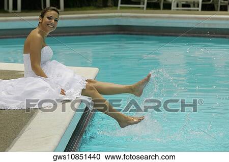 Portrait of a bride sitting a the poolside and smiling View Large Photo Image Stock Image - Portrait of a bride sitting a the poolside and smiling. Fotosearch