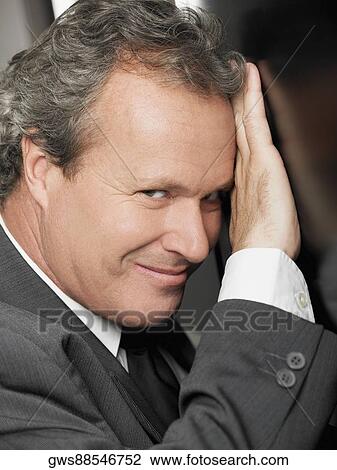Portrait of a businessman grinning View Large Photo Image Stock Image - Portrait of a businessman grinning. Fotosearch