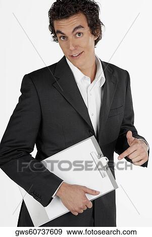 Portrait of a businessman holding a clipboard and making a face View Large Photo Image Stock Photo - Portrait of a businessman holding a clipboard and making a face. Fotosearch
