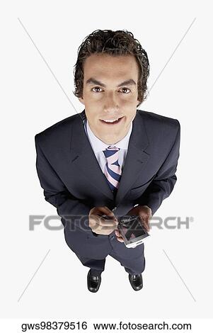 Portrait of a businessman holding a personal data assistant View Large Photo Image Stock Photograph - Portrait of a businessman holding a personal data assistant. Fotosearch