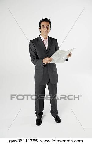 Portrait of a businessman holding a newspaper View Large Photo Image Stock Photography - Portrait of a businessman holding a newspaper. Fotosearch