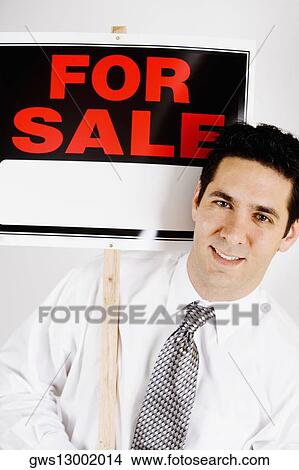 Portrait of a businessman holding For Sale sign board View Large Photo Image Picture - Portrait of a businessman holding For Sale sign board. Fotosearch