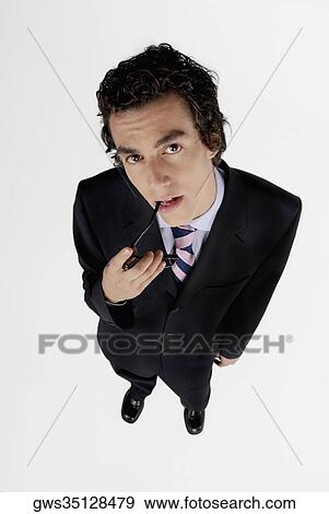 Portrait of a businessman holding his sunglasses View Large Photo Image Stock Photo - Portrait of a businessman holding his sunglasses. Fotosearch
