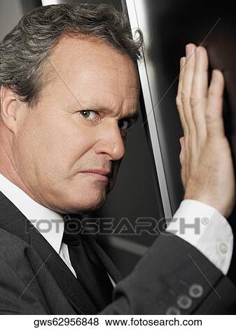 Stock Photo - Portrait of a businessman looking furious. Fotosearch