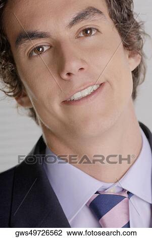 Stock Image - Portrait of a businessman smiling. Fotosearch