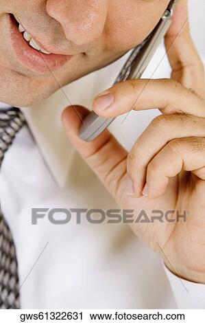 Portrait of a businessman talking on a mobile phone View Large Photo Image Stock Image - Portrait of a businessman talking on a mobile phone. Fotosearch