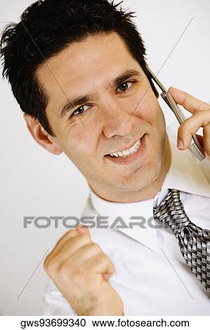 Portrait of a businessman talking on a mobile phone and smiling View Large Photo Image Stock Image - Portrait of a businessman talking on a mobile phone and smiling. Fotosearch