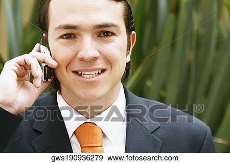 Portrait of a businessman talking on a mobile phone and smiling View Large Photo Image Stock Photo - Portrait of a businessman talking on a mobile phone and smiling. Fotosearch