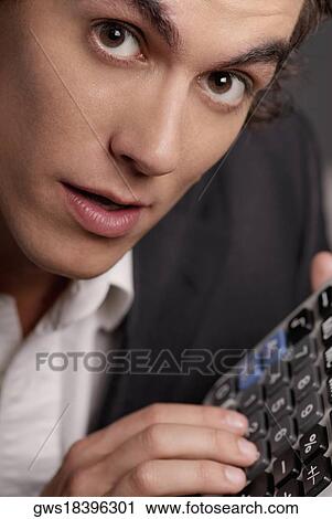 Portrait of a businessman using a calculator View Large Photo Image Stock Image - Portrait of a businessman using a calculator. Fotosearch
