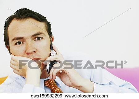 Stock Photo - Portrait of a businessman using a mobile phone. Fotosearch