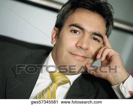 Stock Image - Portrait of a businessman with his head in his hand. Fotosearch