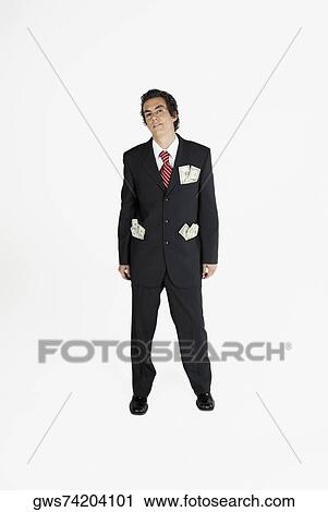 Portrait of a businessman with paper currency in his pockets View Large Photo Image Stock Image - Portrait of a businessman with paper currency in his pockets. Fotosearch