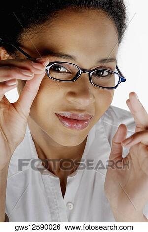 Portrait of a businesswoman adjusting her eyeglasses View Large Photo Image Stock Photograph - Portrait of a businesswoman adjusting her eyeglasses. Fotosearch