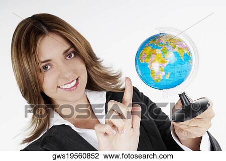 Portrait of a businesswoman holding a globe and smiling View Large Photo Image Stock Image - Portrait of a businesswoman holding a globe and smiling. Fotosearch
