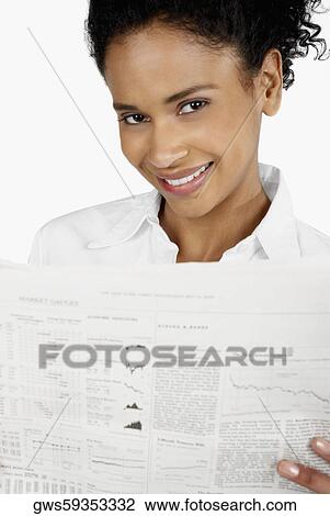 Portrait of a businesswoman holding a financial newspaper and smiling View Large Photo Image Stock Image - Portrait of a businesswoman holding a financial newspaper and smiling. Fotosearch