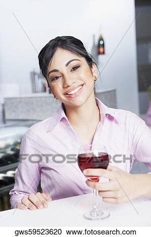 Portrait of a businesswoman holding a glass View Large Photo Image Stock Image - Portrait of a businesswoman holding a glass. Fotosearch