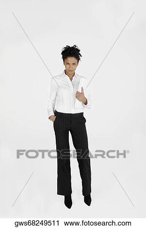 Portrait of a businesswoman holding a laptop with her hand in her pocket View Large Photo Image Stock Image - Portrait of a businesswoman holding a laptop with her hand in her pocket. Fotosearch
