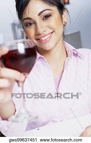 Portrait of a businesswoman holding a glass View Large Photo Image Stock Image - Portrait of a businesswoman holding a glass. Fotosearch