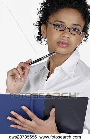 Portrait of a businesswoman holding a file with a pen View Large Photo Image Stock Photograph - Portrait of a businesswoman holding a file with a pen. Fotosearch