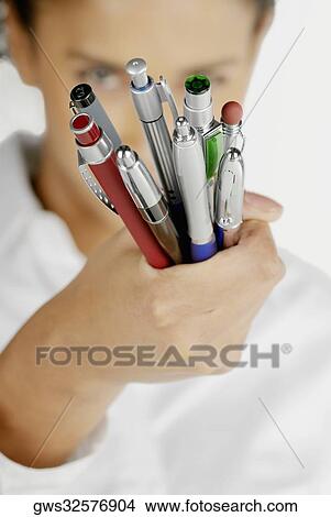 Portrait of a businesswoman holding pens View Large Photo Image Picture - Portrait of a businesswoman holding pens. Fotosearch