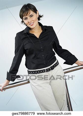 Portrait of a businesswoman leaning against a railing View Large Photo Image Stock Photo - Portrait of a businesswoman leaning against a railing. Fotosearch