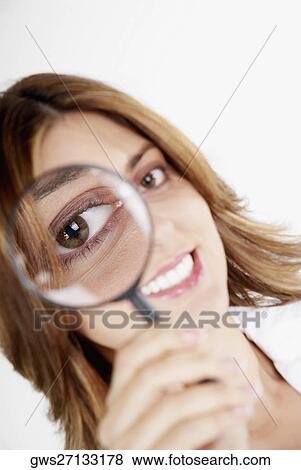 Portrait of a businesswoman looking through a magnifying glass View Large Photo Image Stock Photo - Portrait of a businesswoman looking through a magnifying glass. Fotosearch