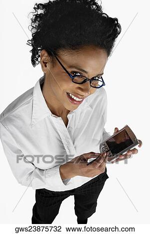 Portrait of a businesswoman operating a hand held device with a digitized pen View Large Photo Image Stock Image - Portrait of a businesswoman operating a hand held device with a digitized pen. Fotosearch