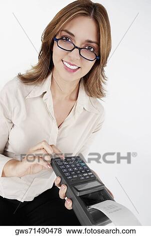 Portrait of a businesswoman operating a credit card reader and smiling View Large Photo Image Stock Photo - Portrait of a businesswoman operating a credit card reader and smiling. Fotosearch
