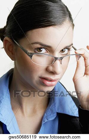 Portrait of a businesswoman peeking over her eyeglasses View Large Photo Image Stock Photo - Portrait of a businesswoman peeking over her eyeglasses. Fotosearch