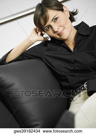 Portrait of a businesswoman smiling and talking on a mobile phone View Large Photo Image Picture - Portrait of a businesswoman smiling and talking on a mobile phone. Fotosearch