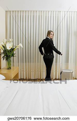 Portrait of a businesswoman standing with a suitcase View Large Photo Image Stock Photograph - Portrait of a businesswoman standing with a suitcase. Fotosearch